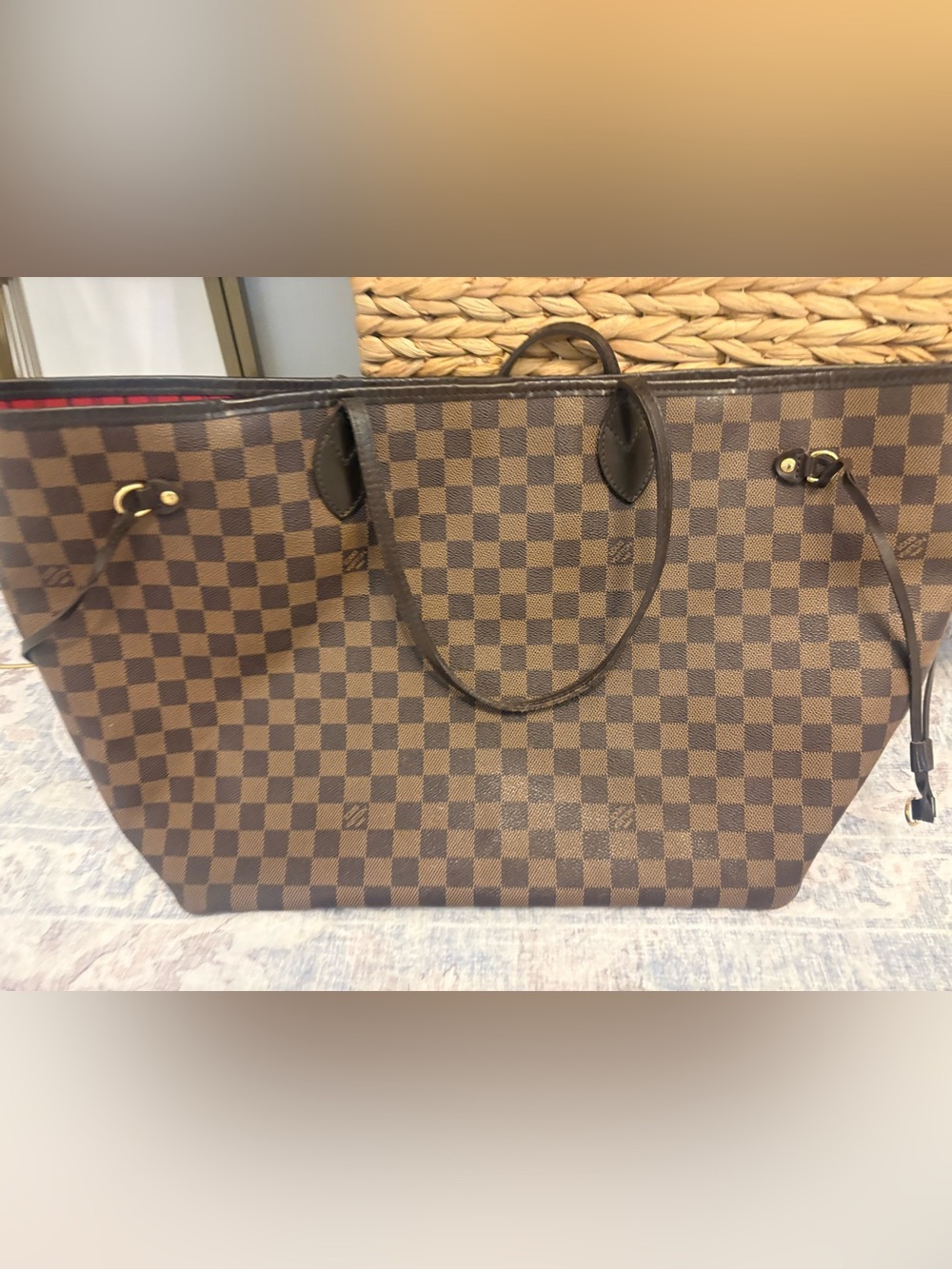 Large Louis Vuitton Neverfull tote in Damier Ebene canvas.